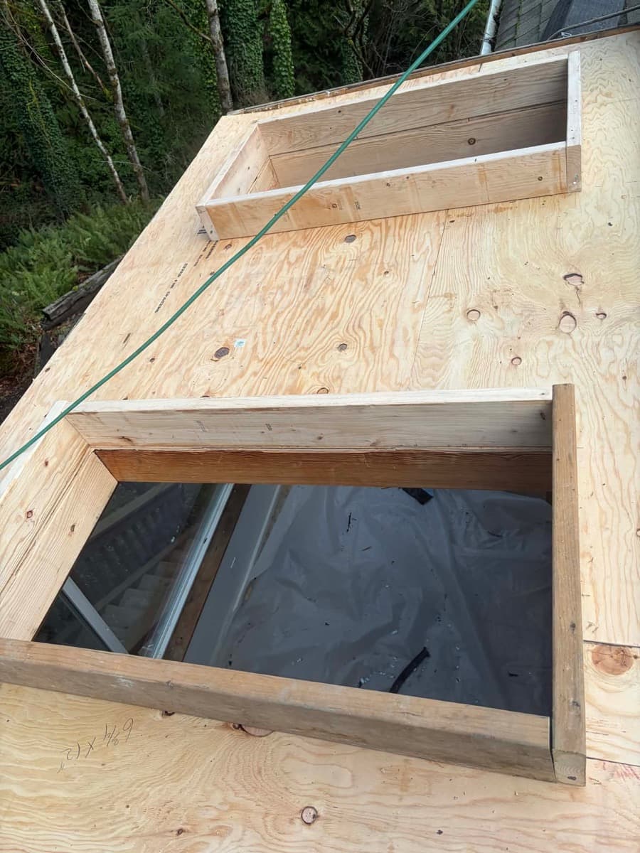 Plywood roof decking with a framed opening, bare and ready to inspect before underlayment goes on