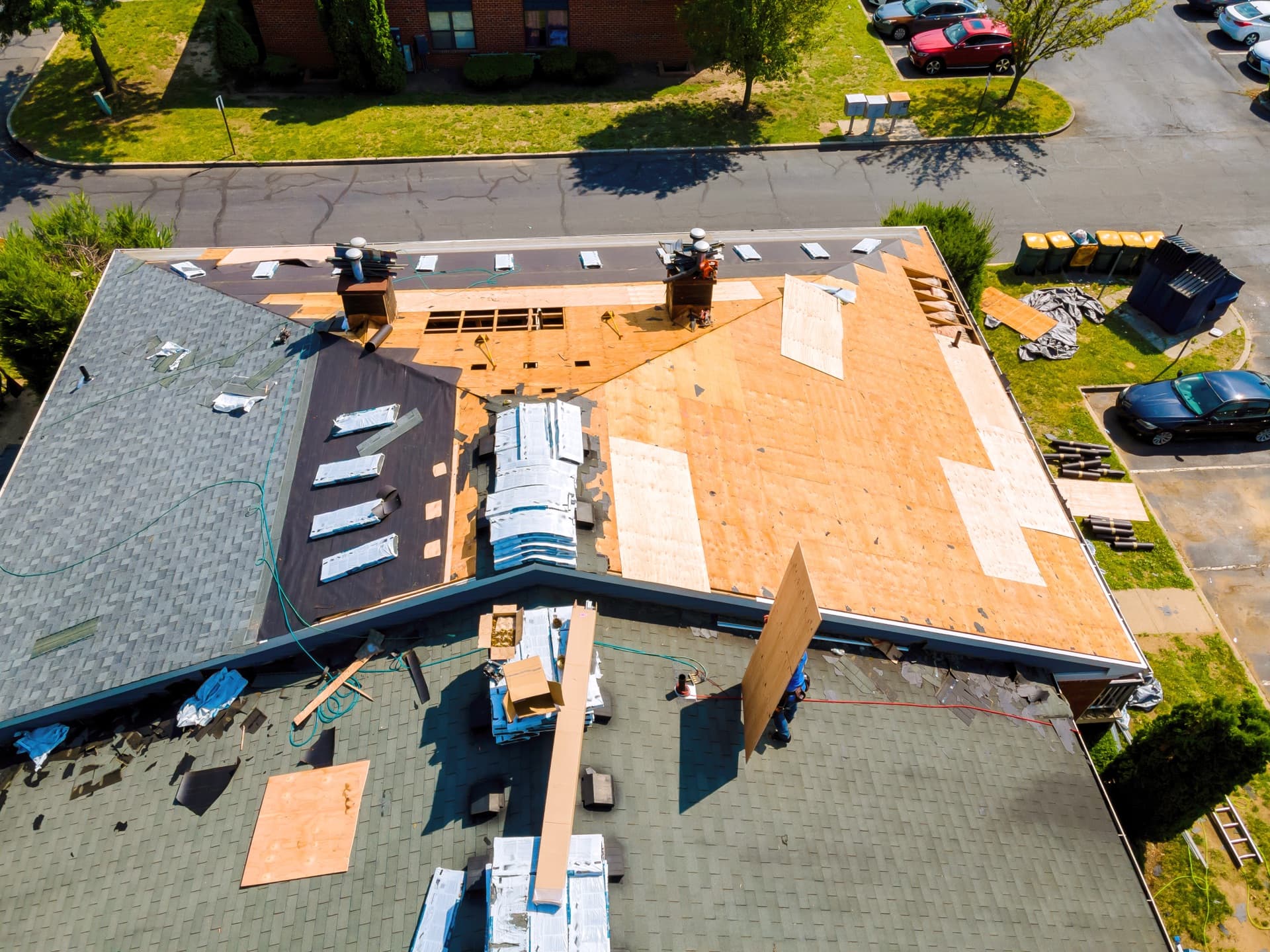 Roofer inspecting shingles during a Puget Sound repair job