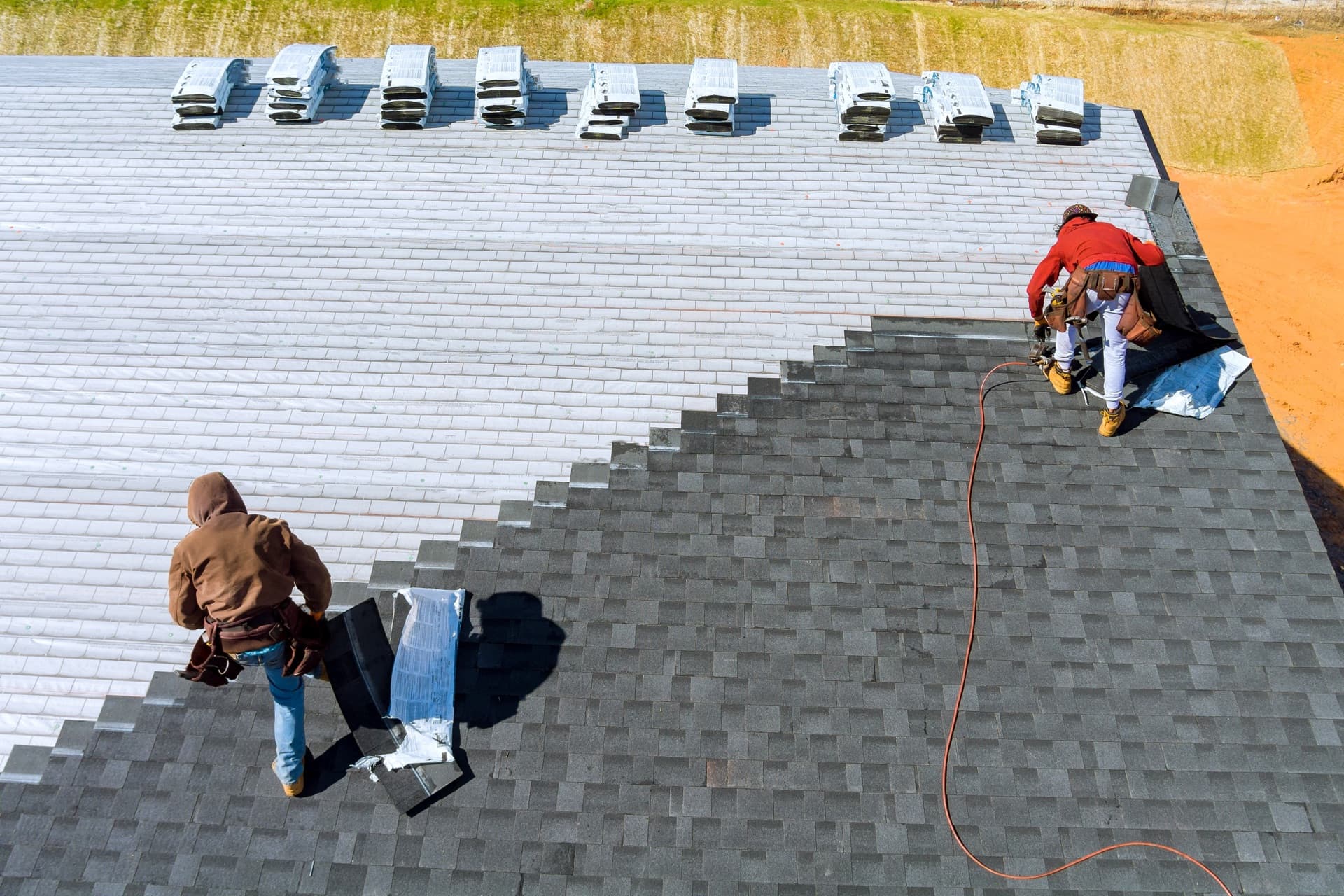 Roofer installing new architectural shingles on a Bellevue home